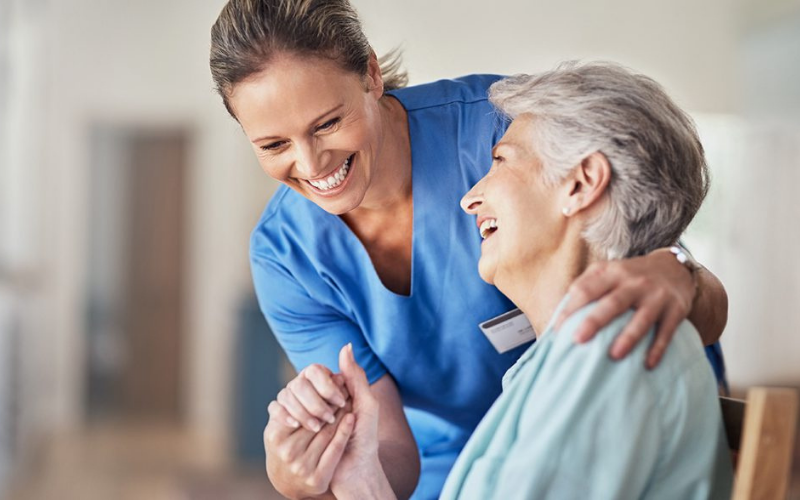 Caregiver helping elderly lady at home